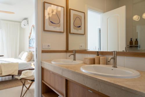 a bathroom with two sinks and a bedroom at Mosaico Ocean View Boutique Apartment in Adeje