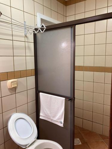 a bathroom with a toilet and a shower stall at Ilha Náutica in Florianópolis