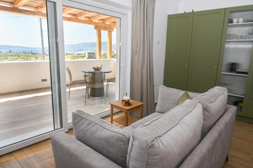 a living room with a couch and a table at Olive - Volia deluxe apartments in Adamas