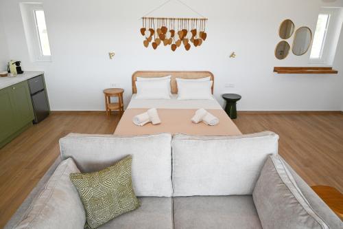 a living room with a couch and a table at Olive - Volia deluxe apartments in Adamas