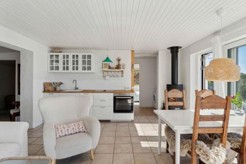 a kitchen and living room with a table and chairs at Lovely Beach House With Panoramic View in Martofte