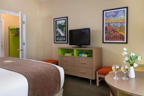 a hotel room with a bed and a flat screen tv at Bar Harbor Motel in Bar Harbor
