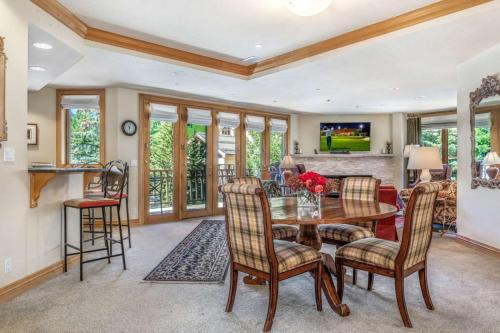 a kitchen and living room with a table and chairs at Ski In, Ski Out 3 Bedroom In Beaver Creek Village With Excellent Mountain Views in Beaver Creek