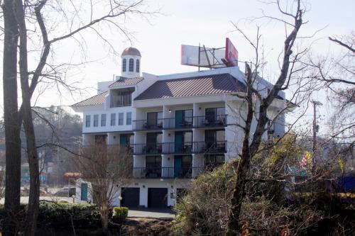 a white building with a tower on top of it at Rivergate Mountain Lodge in Pigeon Forge