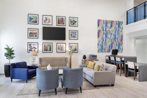 a living room with a couch and chairs at Best Western Plus Executive Hotel & Suites in Sulphur