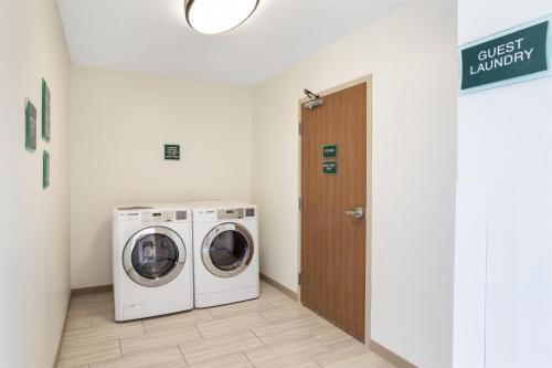 a laundry room with a washer and dryer at Best Western Plus Executive Hotel & Suites in Sulphur