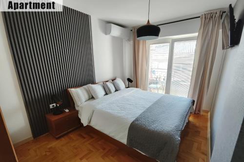 a bedroom with a bed and a large window at Apartments FANTASY with Free Parking in Ohrid