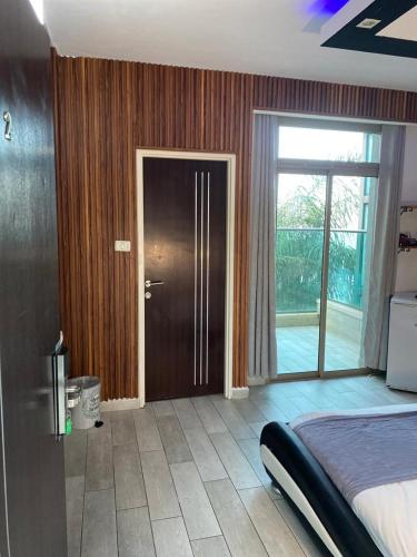 a bedroom with a bed and a sliding glass door at the royal lake views in Tiberias