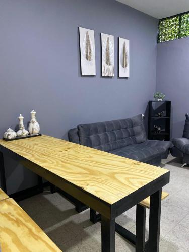 a wooden table in a living room with a couch at Casa Alameda in Mexico City