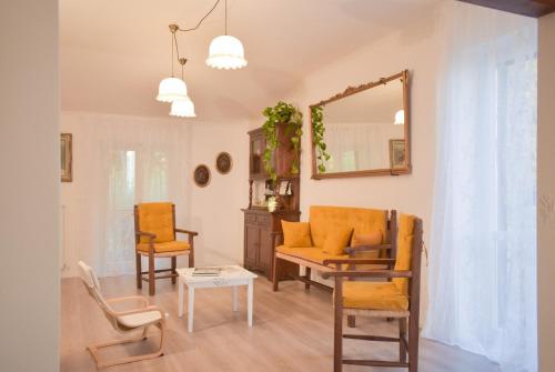 a living room with orange chairs and a mirror at Domus Aromatica in Assisi