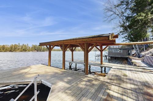 a wooden dock with a gazebo on the water at Stone Lake View in Manitowish Waters
