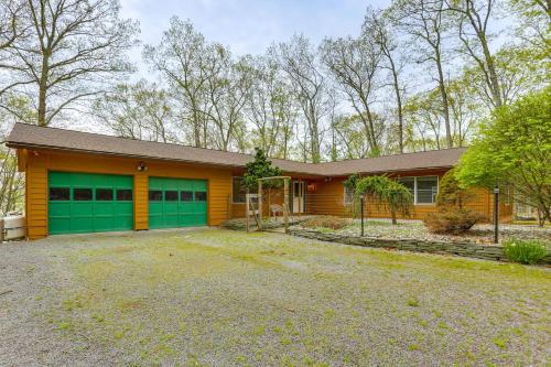 a yellow house with a green garage at half Mi to Boat Ramp Lake Wallenpaupack Retreat! in Lakeville