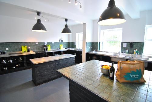 a large kitchen with a counter with a bag on it at The Rocks at Plas Curig Hostel in Capel Curig