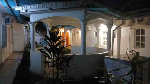 a house with a bath tub in a yard at night at Ngoyo station puma in Motsouémbé