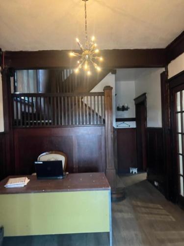 a dining room with a table and a ceiling light at Valley and city views in Steubenville