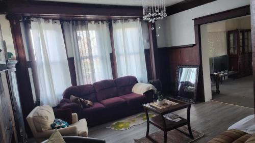 a living room with a purple couch and a table at Valley and city views in Steubenville