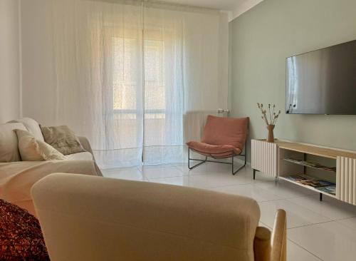 a living room with a couch and a tv at Casa Spartea Cilento coast in Marina di Camerota