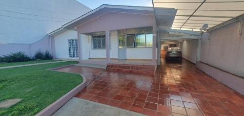 a house with a brick walkway in front of it at Casa no São Cristóvão in Cascavel