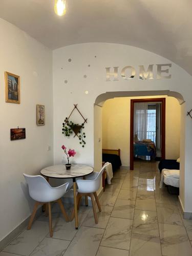 una sala da pranzo con un tavolo e sedie in una stanza di 'A tarantella a Napoli