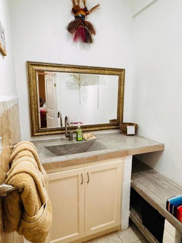 a bathroom with a sink and a mirror at Vaquita Marina House in Puerto Peñasco