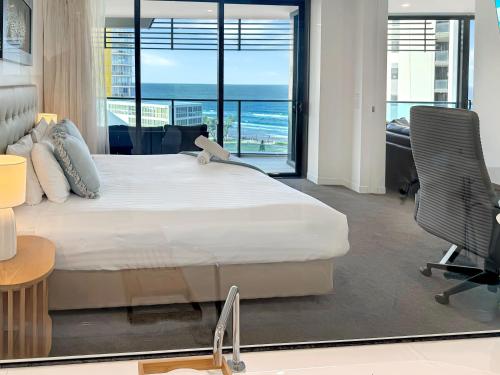 a bedroom with a bed and a view of the ocean at Oracle 11th floor Tower 1 - GC Getaways in Gold Coast