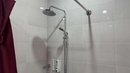 a bathroom with a shower with a shower head at Chinor Hotel Fergana in Fergana