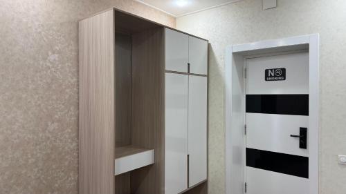 a white cabinet with a no smoking sign in a room at Chinor Hotel Fergana in Fergana