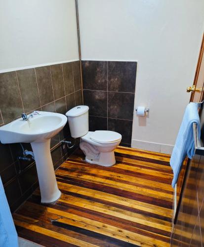 a bathroom with a toilet and a sink at Travel Hotel Quito in Quito