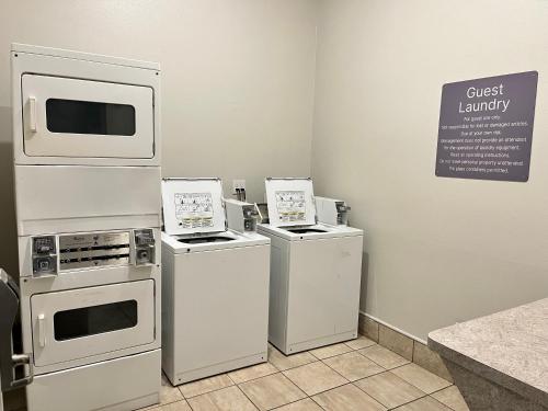 a room with three appliances and a sign on the wall at Sonesta Essential North Houston in Houston