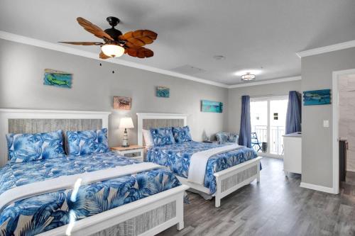 a bedroom with two beds and a ceiling fan at Ocean Isles Peace and Serenity in Marathon