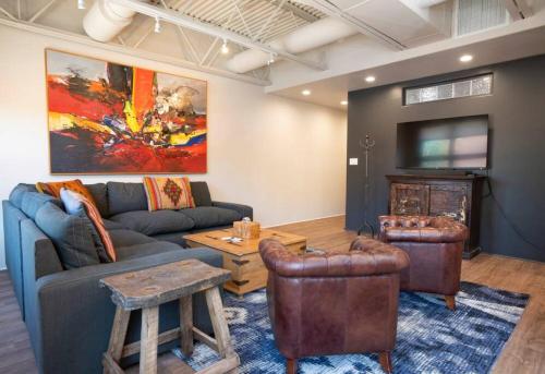 a living room with a couch and a flat screen tv at Luxury in the Heart of Historic Downtown Santa Fe 1050 Sq Ft in Santa Fe