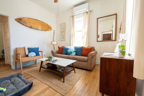 a living room with a couch and a table at Breezy 1BR Retreat Walk to UofA and Spring Fun in Tucson
