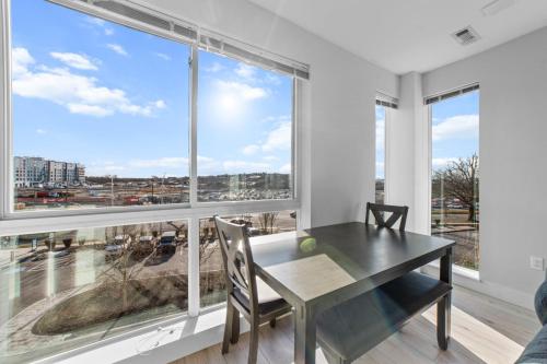 a dining room with a table and a large window at 2 Bedroom apartment in Revere