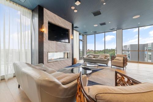 a living room with couches and a flat screen tv at 2 Bedroom apartment in Revere