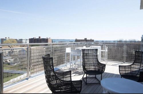 a deck with chairs and a table on a balcony at 2 Bedroom apartment in Revere