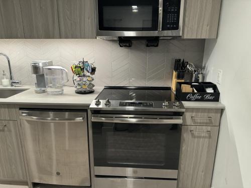 a kitchen with a stove and a microwave at 2 Bedroom apartment in Revere