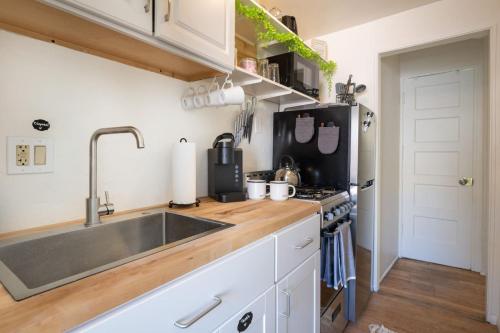 a kitchen with a sink and a stove at Spring Oasis Tucson 1BR 5 Min to UofA and Fun in Tucson