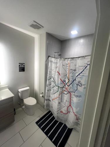 a bathroom with a shower curtain with a map at Luxurious 1BR, Pool, Gym, nr Blue Line in Revere