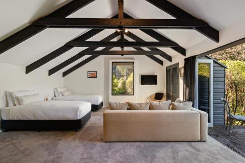 a living room with two beds and a couch at Baywaters Retreat by Sothebys Luxury Rental Homes in Closeburn