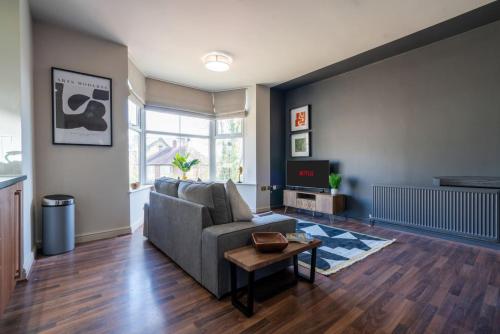 a living room with a couch and a table at Park View, Sheffield in Sheffield