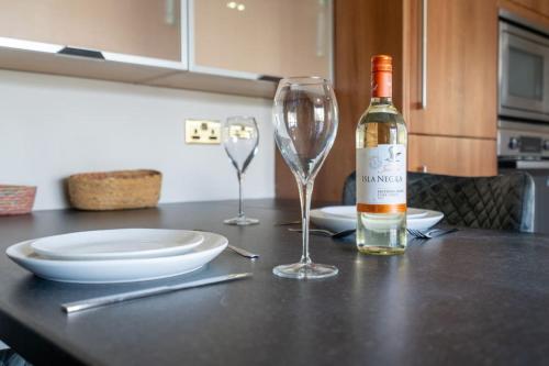 a bottle of wine and two glasses on a table at Park View, Sheffield in Sheffield