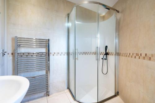 a shower with a glass door in a bathroom at Park View, Sheffield in Sheffield