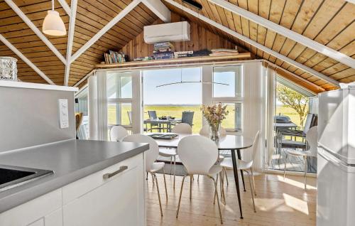 a kitchen and dining room with a table and chairs at Nice Home In Vinderup With Kitchen in Vinderup