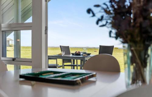 a table with two laptops on it with a window at Nice Home In Vinderup With Kitchen in Vinderup