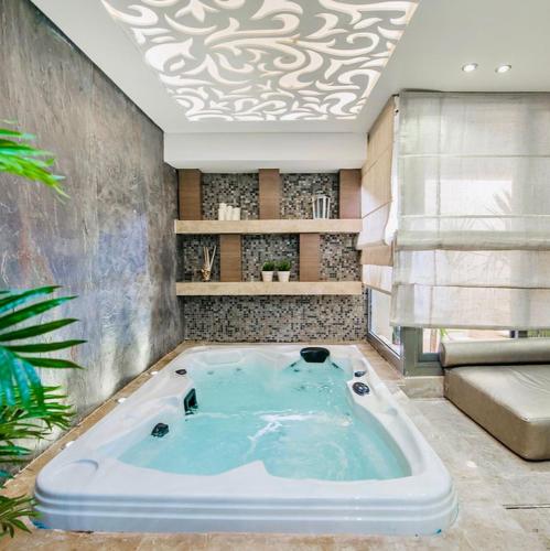 a hot tub in a room with a ceiling at Reno Villa 4Br in Sheikh Zayed