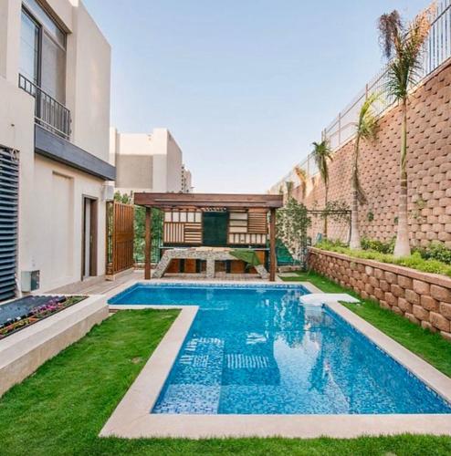 a swimming pool in the backyard of a house at Reno Villa 4Br in Sheikh Zayed