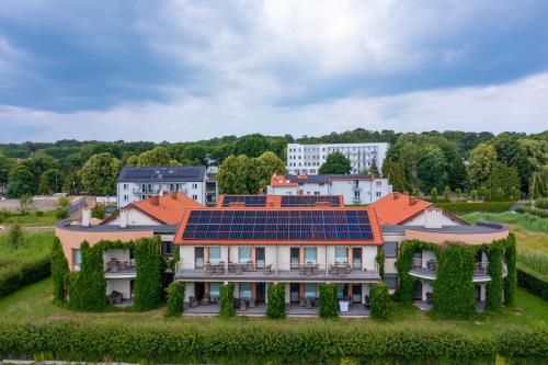 a house with solar panels on its roof at ATRIUM Apartamenty in Krynica Morska