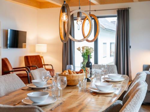 a wooden table with chairs and a dining room at Obermöschach 5A in Obermöschach