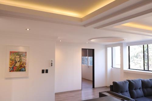 a living room with a couch and a ceiling at SanRafa Home Office Suites in Mexico City