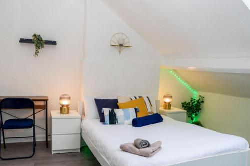 a bedroom with a white bed and a chair at Entire Cosy 1 Bedroom Flat in Brightside